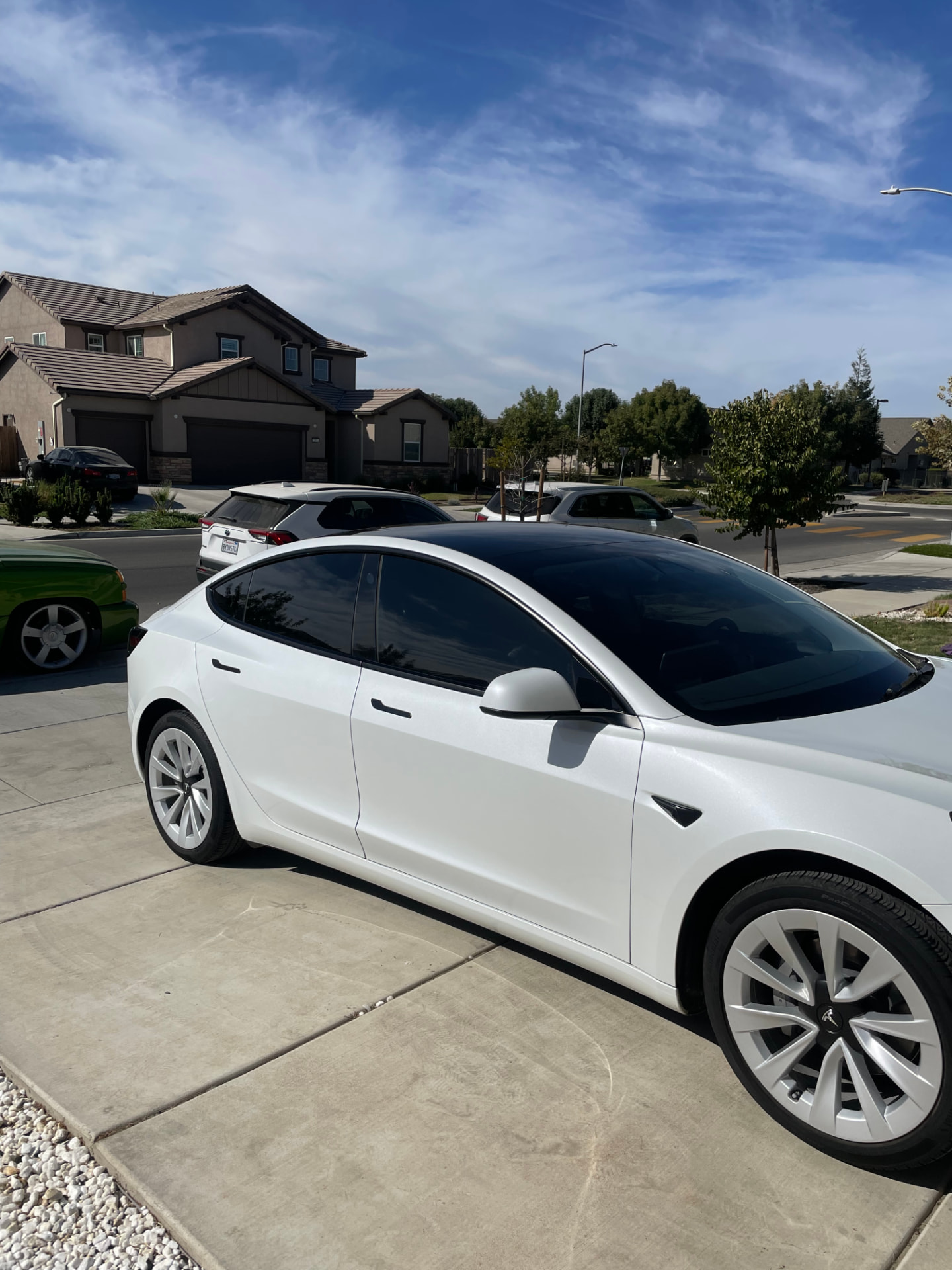 White Tesla Model 3 with dark tinted side windows after a mobile tint appointment