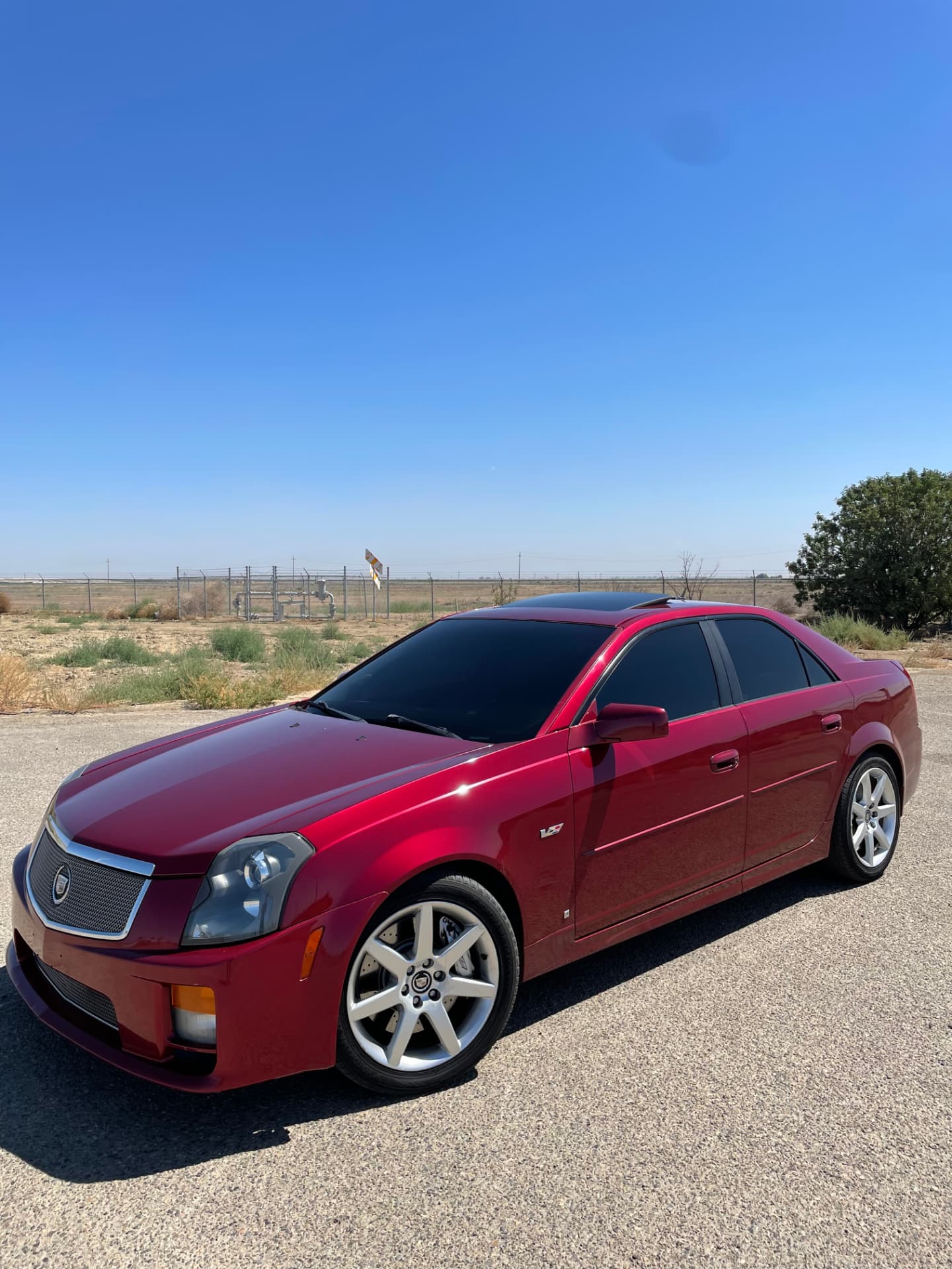 Red Cadillac CTS-V with professionally installed dark window tint, photographed in the Fresno area
