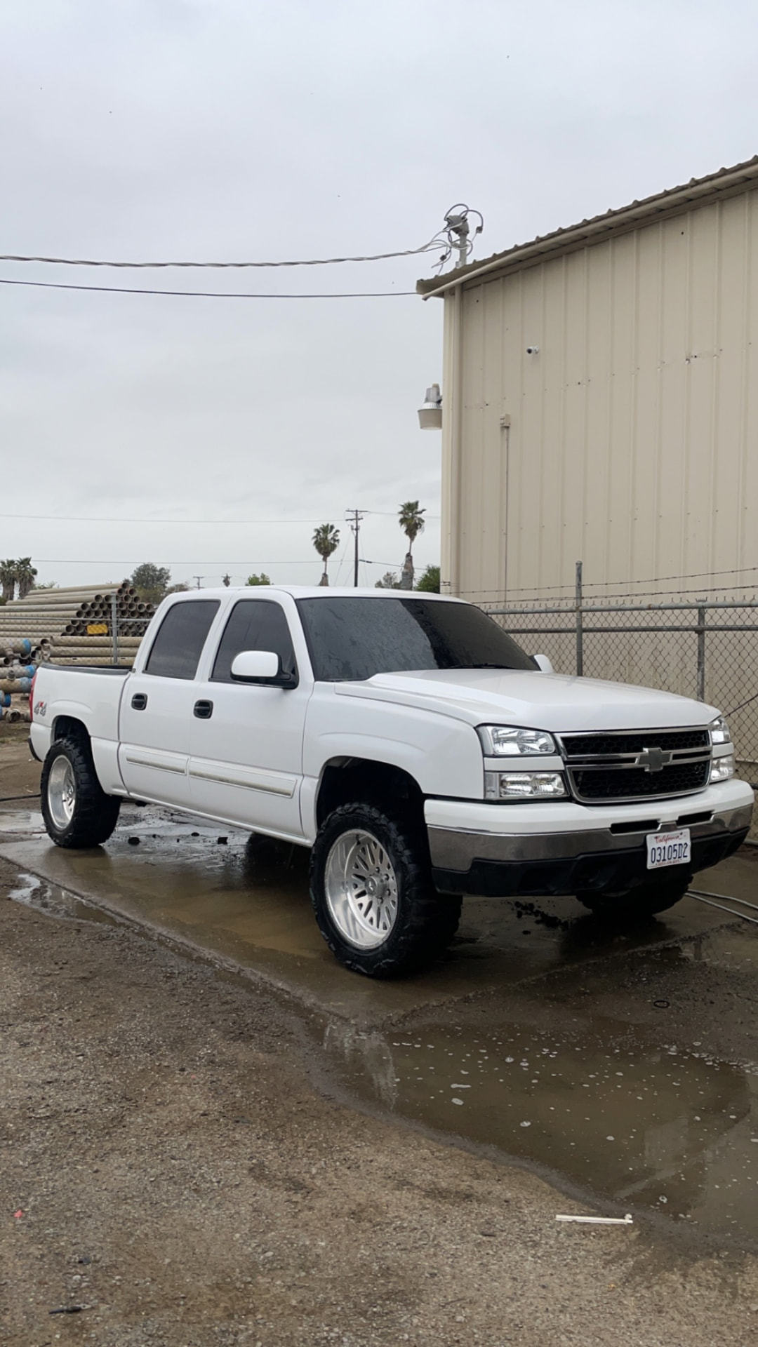White lifted Chevrolet Silverado crew cab with tinted windows